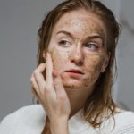 Can using a body scrub cause breakouts on the face?