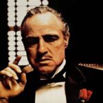 Why is Luca Brasi portrayed as being strong and fearless despite being a hired goon?