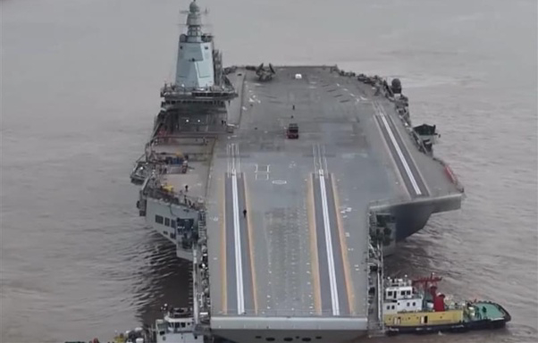 How does China's new supercarrier compare to US carriers in terms of design features and technology level?