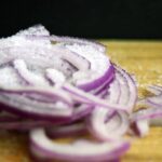 Does eating lots of raw onions with salad beneficial to health?